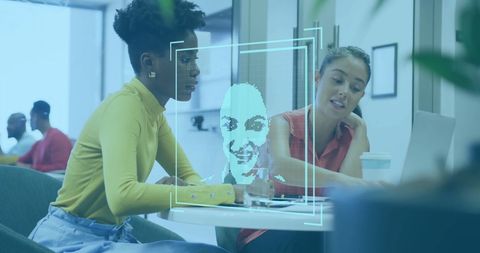 Diverse Colleagues Discuss Project with Facial Recognition Overlay