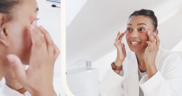 Woman Applying Under Eye Patches in Mirror for Skincare Routine - Download Free Stock Images Pikwizard.com