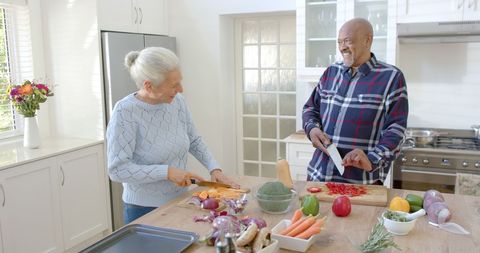 Happy Senior Couple Preparing Fresh Vegetables Together