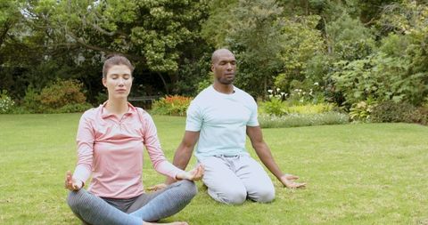 Diverse Couple Meditating Outdoors in Park Serenity Yoga