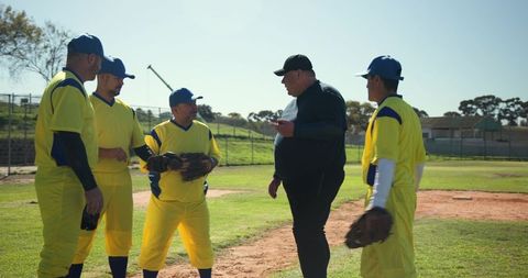 Baseball team huddling with umpire on sunny infield discussing play and game strategy