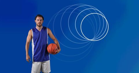 Basketball player holding ball against futuristic blue background