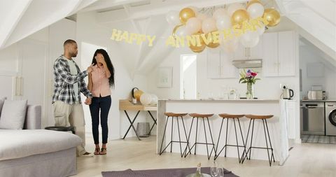 Interracial Couple Celebrating Anniversary with Home Party and Decor