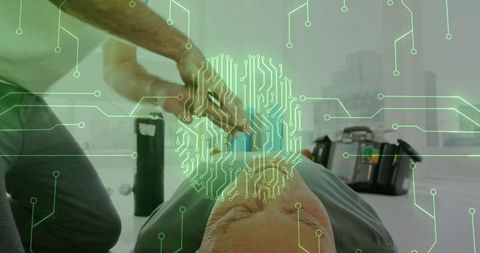 Man using defibrillator in high-tech medical setting