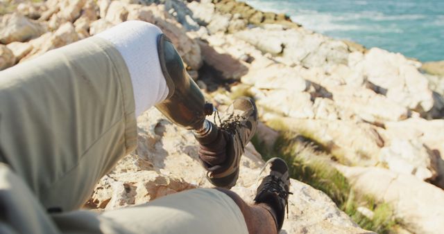 Person with Prosthetic Leg Relaxing on Rocky Beach - Download Free Stock Images Pikwizard.com