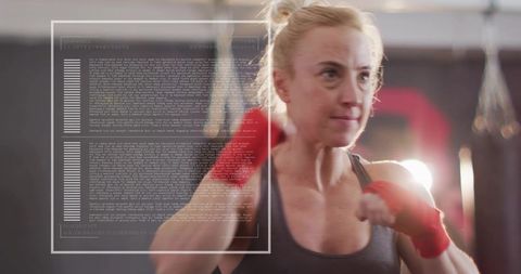 Female boxer training delivering focused punch with red hand wraps and hud overlay