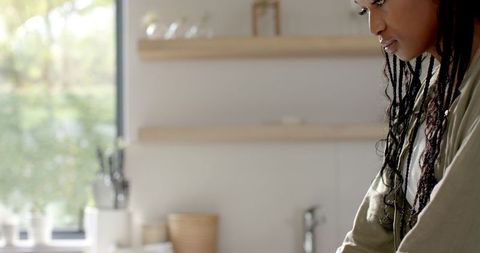Young Woman Engaging on Laptop in Modern Kitchen