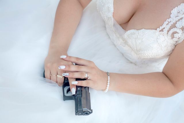 Bride Holding Handgun with Decorative Nails in Wedding Dress - Download Free Stock Photos Pikwizard.com