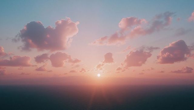 Tranquil Ocean Sunrise with Pastel Clouds