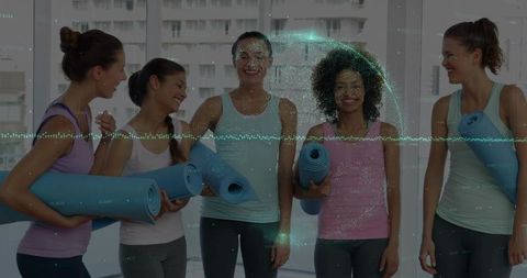 Group of Women Holding Yoga Mats in Fitness Studio Collaborating