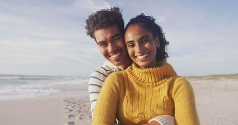Happy Couple Embracing on Sandy Beach During Vacation