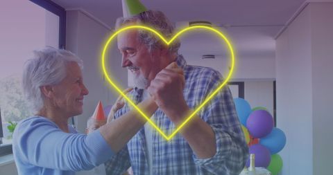 Senior Couple Dancing Joyfully at Birthday Celebration