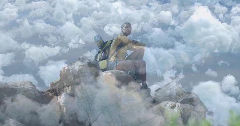 Mountain Adventurer Gazing at Cloud-Filled Horizon