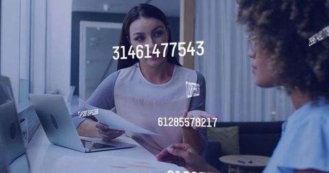 Manager explaining report with data overlays while collaborating at glass office counter