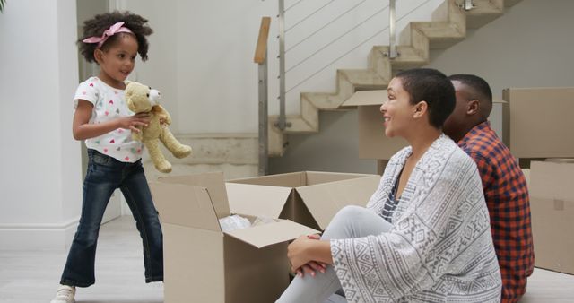 Family Moving into New Home Unpacking Boxes - Download Free Stock Images Pikwizard.com