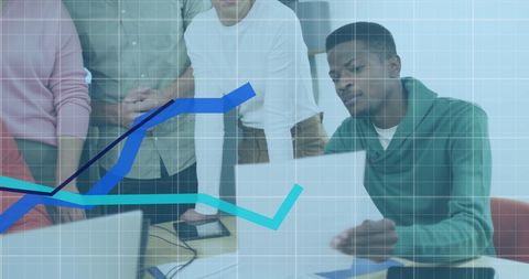 Diverse team analyzing financial data trends in office