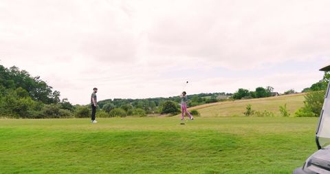 Senior golfers enjoying recreational game on lush golf course