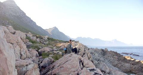 Couple Enjoying Scenic Ocean View on Rocky Mountain Hike