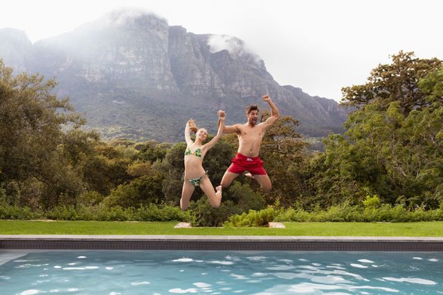 Couple jumping together in the swimming pool - Download Free Stock Photos Pikwizard.com