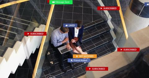 Two professionals collaborating on laptop and tablet, social media notification overlays