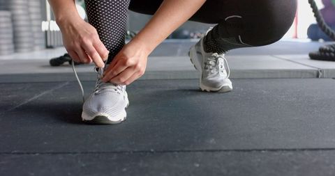 Woman Tying Shoelaces Before Gym Workout - Download Free Stock Images Pikwizard.com