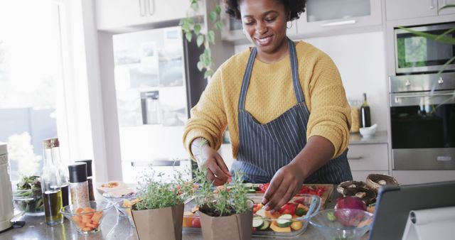 Smiling woman preparing healthy salad in modern kitchen - Download Free Stock Images Pikwizard.com