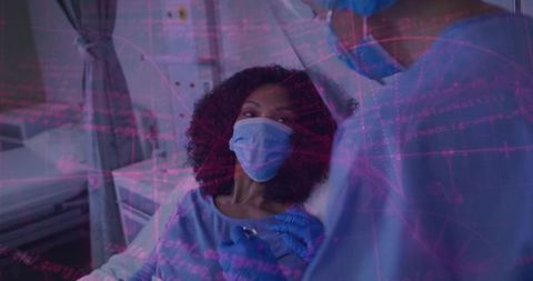 Patient receiving vaccine from clinician in ppe at clinic chair with privacy curtain