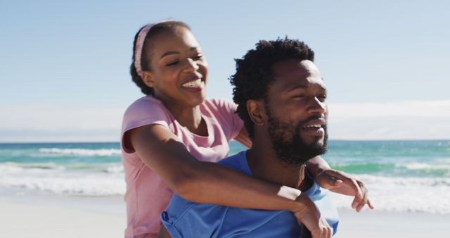 Happy Couple Enjoying Beach Piggyback Ride on Sunny Day - Download Free Stock Images Pikwizard.com