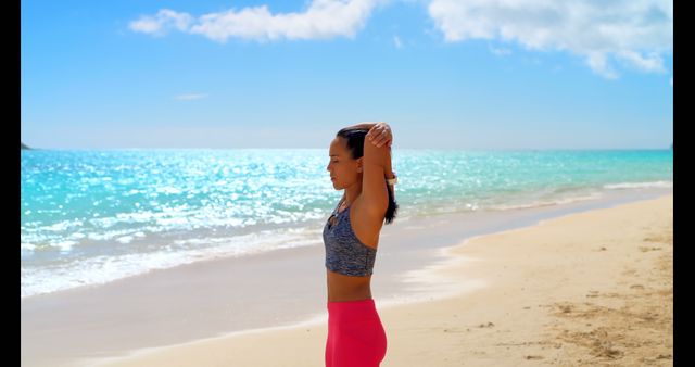 Woman Stretching on Sunny Beach with Ocean Background - Download Free Stock Images Pikwizard.com