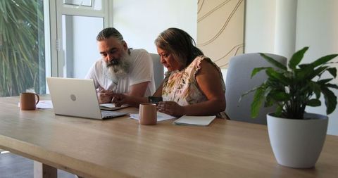 Senior couple engaging in online shopping at home