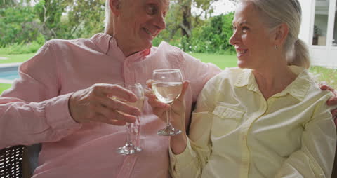 Senior Couple Enjoying Wine in Garden