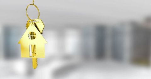 Gold house key fob with keys in elegant modern kitchen