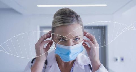 Clinician adjusting surgical mask in hospital corridor with dna helix overlay
