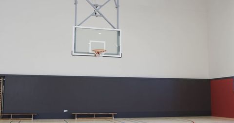 Indoor Basketball Court with Gray Walls and Hoop