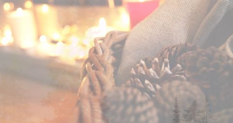 Cozy Christmas Scene with Candles and Pine Cones