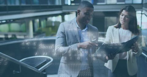 Business Professionals Collaborating in Modern Office Atrium