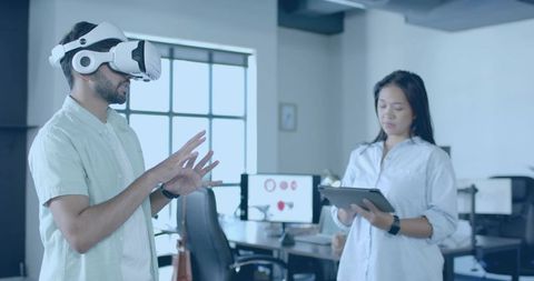 Colleague Using Virtual Reality Headset in Modern Office Environment