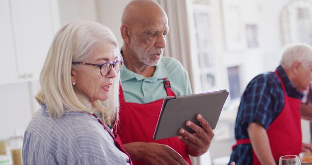 Seniors Cooking Together and Using a Tablet - Download Free Stock Images Pikwizard.com