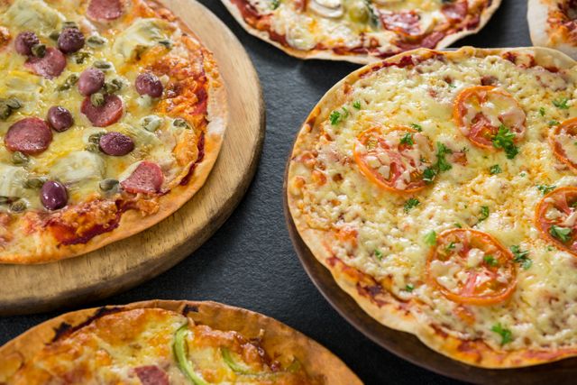 Close-up of various pizza arranged on a wooden tray