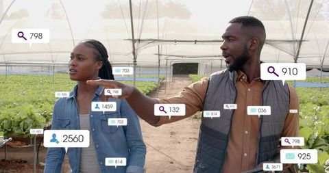 Technicians discussing sustainable farming in smart greenhouse