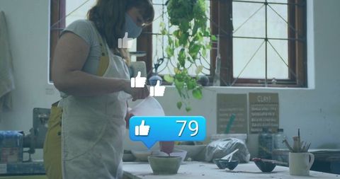 Ceramic artist glazing bowl in art studio with social media engagement