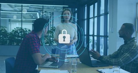 Team discussing cybersecurity and data protection in modern office with padlock overlay