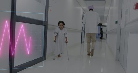 Doctor Assisting Young Girl with Disability in Hospital Corridor