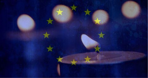 European Flag Over Candles in Darkness Symbolizing Reflection