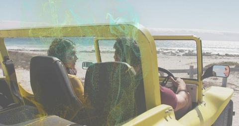 Driving couple in yellow open-top jeep along sunlit coastline enjoying coastal road trip