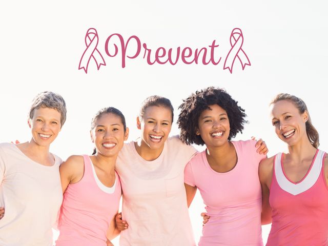 A diverse group of five women standing close together, smiling, and wearing pink shirts. The word 'Prevent' written above them with two pink cancer ribbons on either side indicates their commitment to breast cancer awareness. Useful for health campaigns, awareness programs, and educational materials on breast cancer prevention and support.