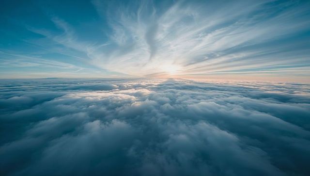 Sunrise Above Vast Cloud Sea with Radiant Cirrus Streaks, Panoramic Aerial Horizon View