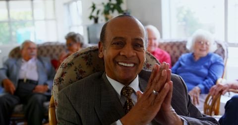 Joyful Senior Man in Nursing Home with Friendly Gathering