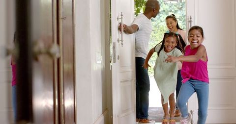 Joyful Family Homecoming: Excited Children Run Ahead of Parents
