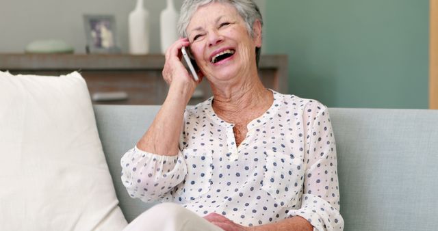 Senior Woman Laughing During Phone Call on Sofa - Download Free Stock Images Pikwizard.com